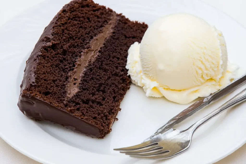 Chocolate pound cake slice with vanilla ice cream on a white plate